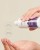 Hands pouring ENVIRON Sebu-Tone Clarifier from the bottle into the palm with AHA and BHA information beside it.