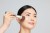Jane Iredale Multiuse Blending Brush applying powder to a model's face.