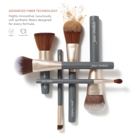 Set of Jane Iredale makeup brushes with graphite handles and soft synthetic bristles.