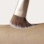 Close-up of a soft Jane Iredale cheek brush sweeping across skin.