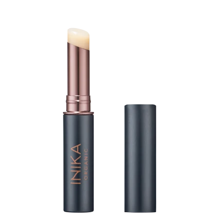 INIKA Organic lip balm stick in a dark graphite matte package with rose-gold detail and a natural clear balm tip.