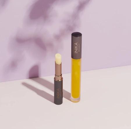 Two INIKA Organic lip care products: Lip Balm on the left and Lip Oil on the right.