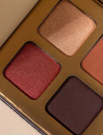 Close-up of INIKA Organic Quad Eyeshadow Palette FLOWERS with warm rose, brick and brown shades.