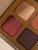 Close-up of INIKA Organic Quad Eyeshadow Palette FLOWERS with warm rose, brick and brown shades.
