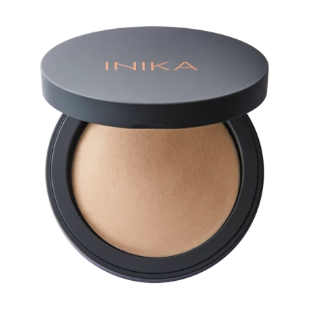 Open INIKA Organic Baked Mineral Foundation compact with beige pressed powder and copper-gold logo.