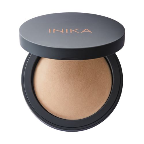 Open INIKA Organic Baked Mineral Foundation compact with beige pressed powder and copper-gold logo.