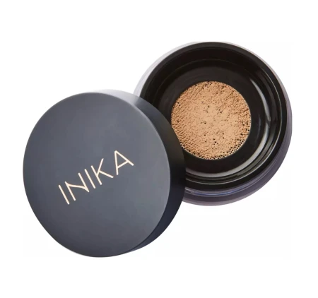 Open jar of INIKA Organic Loose Mineral Foundation SPF25 with sifter and beige mineral powder.