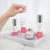 Environ Moisture product line displayed on a marble tray with a hand holding a hydration capsule.