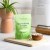 Rejuvenated Skin Perfecting Complex green pack with capsules in a wooden bowl.
