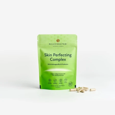 Rejuvenated Skin Perfecting Complex pouch with beige capsules on a grey background.