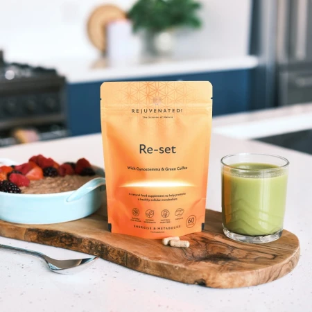 Breakfast scene with oatmeal, green smoothie and orange Rejuvenated Re-Set pack.