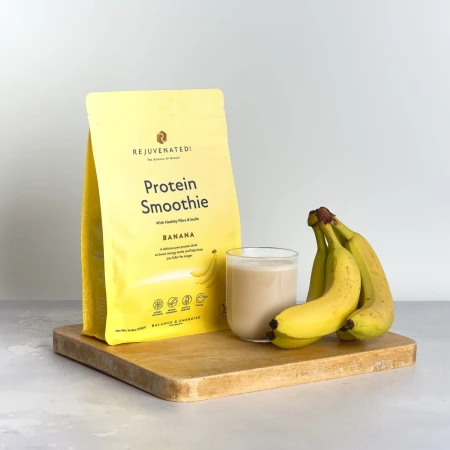 Rejuvenated Protein Smoothie Banana pack with creamy drink and fresh bananas.