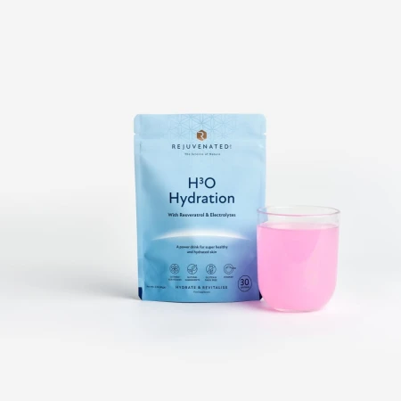 REJUVENATED H3O Hydration Powder sachet with a prepared pink electrolyte drink in a glass