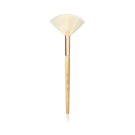 Jane Iredale White Fan Brush with light bristles, wooden handle and gold ferrule.