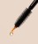 Close-up of an INIKA serum applicator brush with a drop of clear amber serum