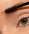 INIKA Lash Brow Serum being brushed through the eyebrow