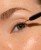 INIKA Lash Brow Serum applicator placed along the upper lash line
