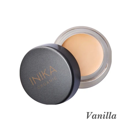 Creamy beige INIKA Organic Full Coverage Concealer presented in its compact jar.