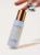 INIKA Organic Hyaluronic Hydration Complex bottle held between fingers