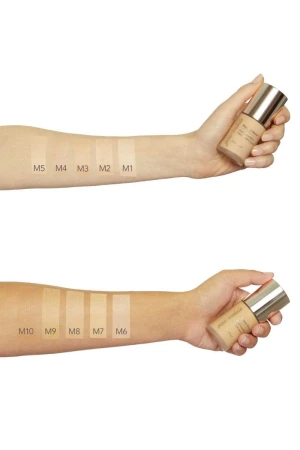 Beyond Matte foundation shades swatched on hands while holding foundation bottles.