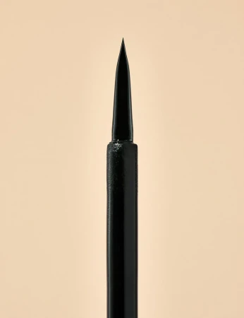 Close-up of the fine pointed applicator of INIKA Organic Liquid Eyeliner Black