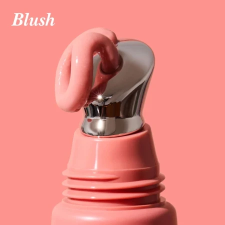 Cooling metal applicator with INIKA Organic Tinted Lip Serum in the Blush shade.