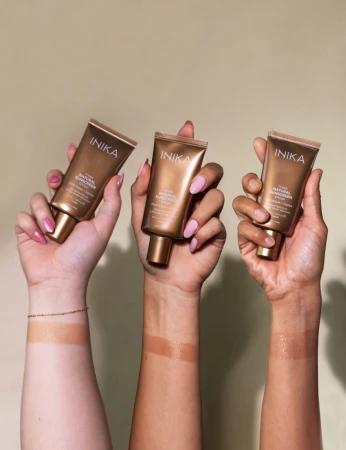 INIKA Tinted Natural Sunscreen SPF50+ shown on different skin tones