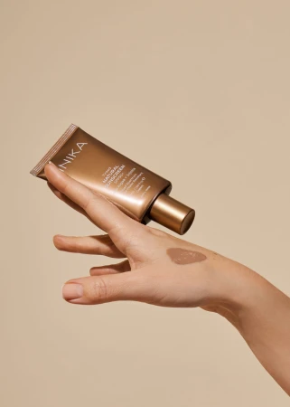 INIKA Tinted Natural Sunscreen SPF50+ texture blended on the hand