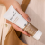Environ RAD ACTIVÉ Antioxidant Sun Cream SPF20 held in hand in a summer lifestyle shot