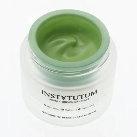 Close-up of an open INSTYTUTUM SuperBiotic Regenerating Cream jar with fresh green silky texture.
