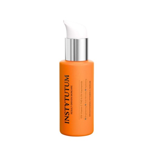 INSTYTUTUM Brightening Vitamin C Serum in an elegant orange pump bottle.