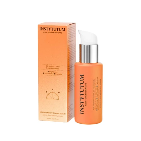 INSTYTUTUM Brightening Vitamin C Serum orange pump bottle with matching orange carton.