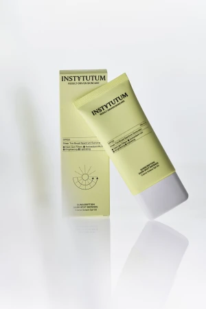 INSTYTUTUM Sunscription Dark Spot Defence SPF50 tube and box on a light background
