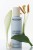 INSTYTUTUM Resurfacing Glow Toner bottle among green leaves and flowers