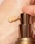 INIKA Organic BB Cream being dispensed from the pump onto the hand, showing its light creamy texture and natural shade.