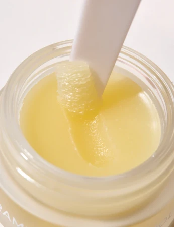 Close-up of INIKA Organic Lip Mask jar with applicator in the smooth formula