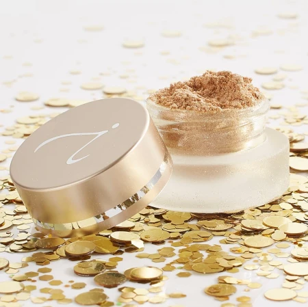 Jane Iredale loose eyeshadow and highlighter in an elegant matte jar with a satin gold lid and the brand logo.