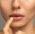 Model makeup look with Jane Iredale 24-Karat GOLD DUST used on the lips for a luminous golden finish.