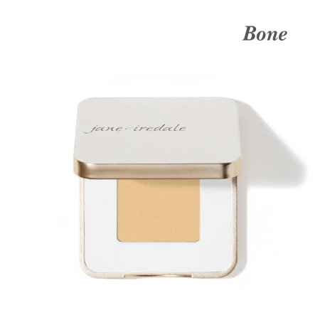 Jane Iredale eyeshadow in Bone, in an elegant white compact with gold trim. Bone is slightly warmer and more yellow than French Vanilla.